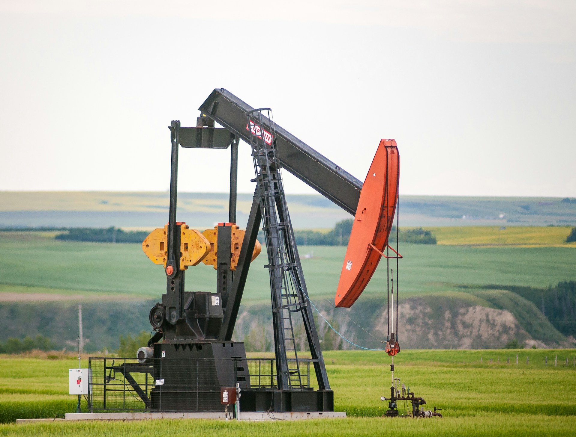 Oil pumpjack in an open field